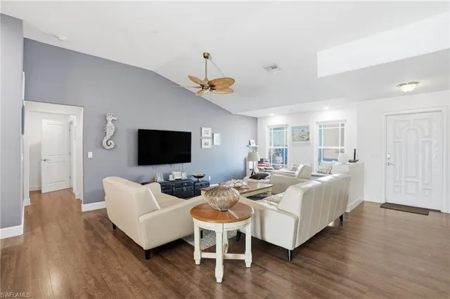 a living room with furniture wooden floor and a flat screen tv