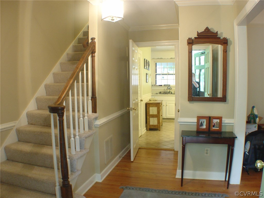 2220 Oakengate Lane Midlothian, VA 23113 - Photo 2 of 17 a view of a hallway with wooden floor and staircase