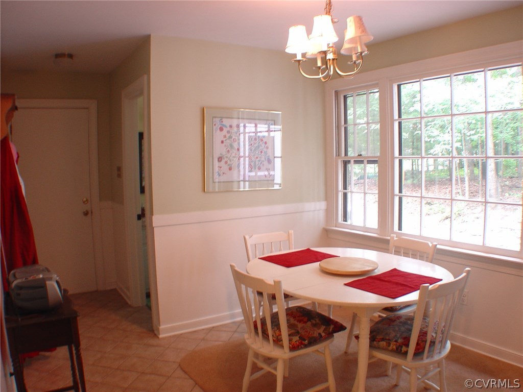 2220 Oakengate Lane Midlothian, VA 23113 - Photo 8 of 17 a dining room with furniture a chandelier and window
