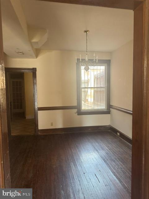 2354 Champlain Street Northwest Washington, DC 20009 - Photo 3 of 5 a view of an empty room with wooden floor and a window