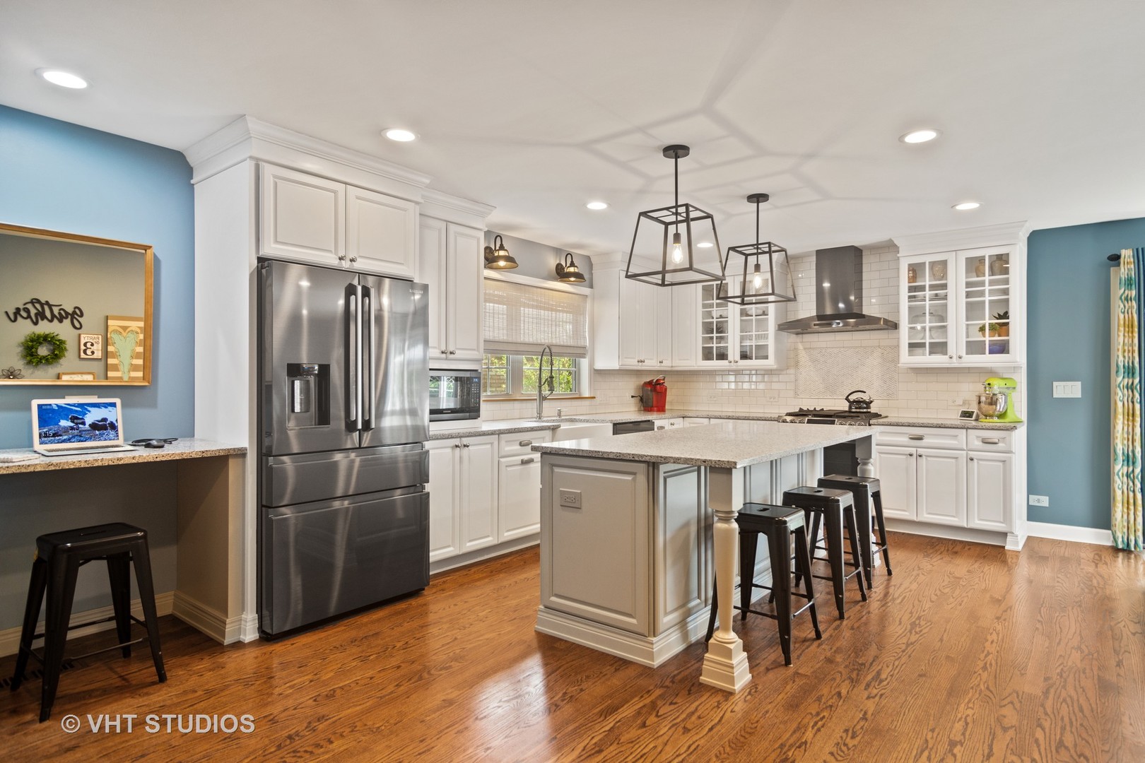624 South Banbury Road Arlington Heights, IL 60005 - Photo 7 of 20 a kitchen with stainless steel appliances granite countertop a refrigerator a stove a sink a dining table and chairs with wooden floor