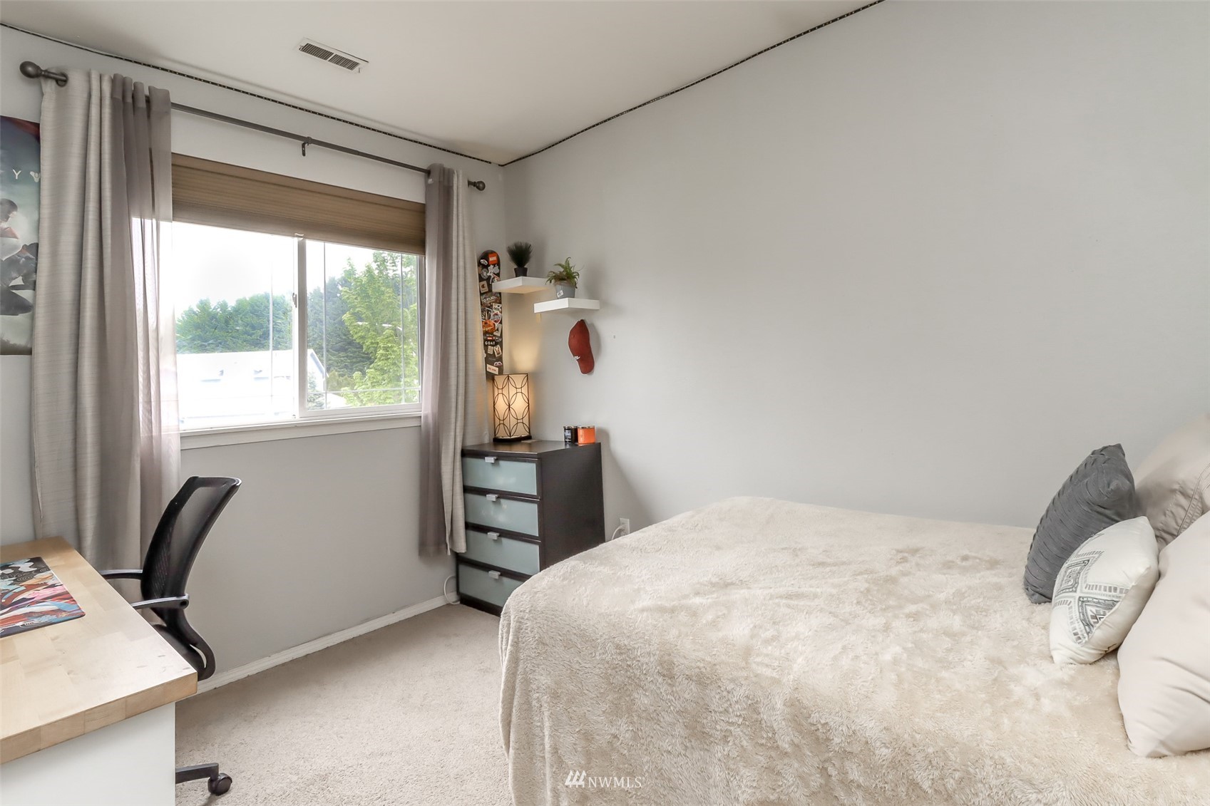 4609 Northeast 7th Place Renton, WA 98059 - Photo 19 of 30 a bedroom with a bed and a window