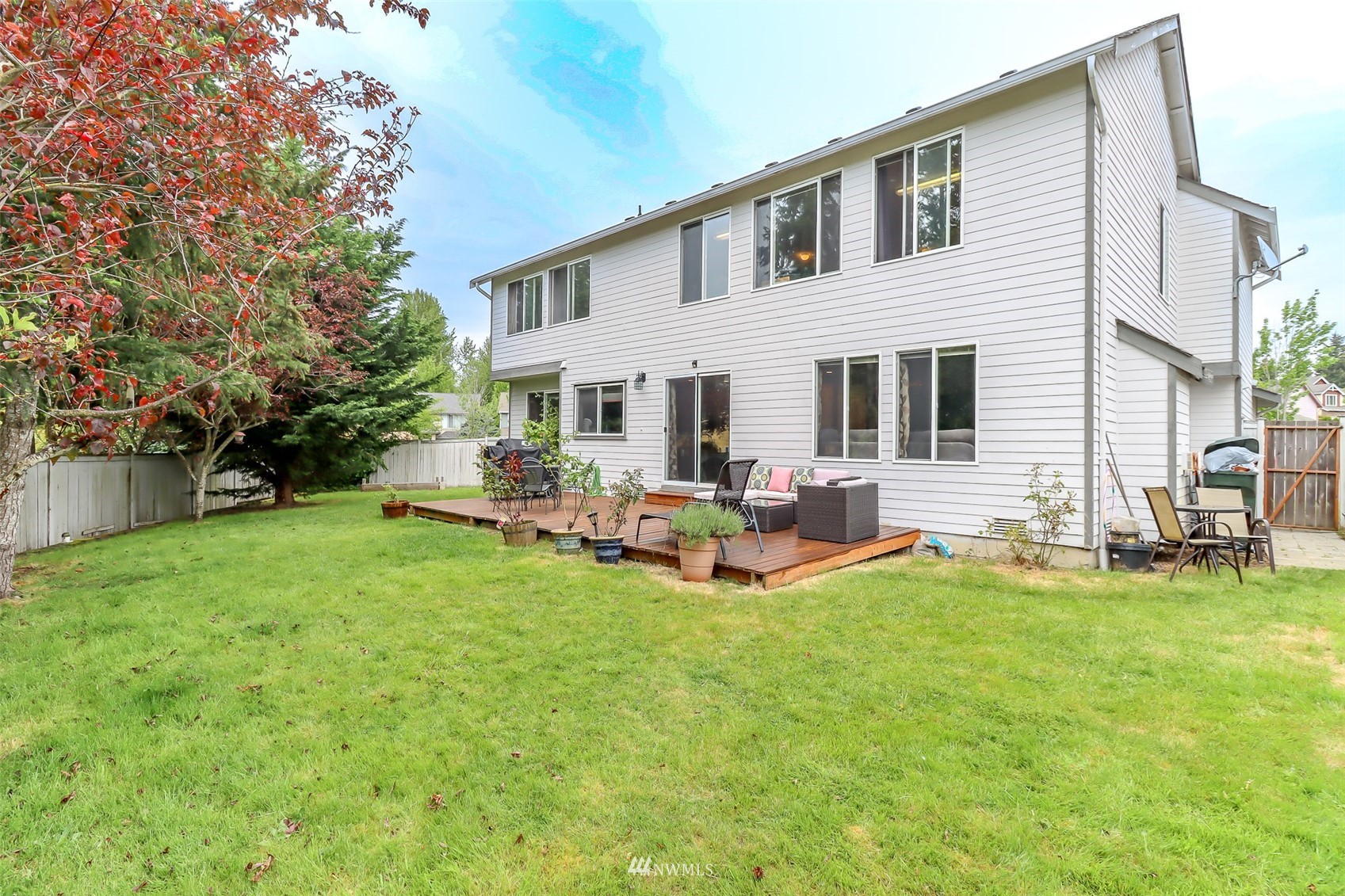 4609 Northeast 7th Place Renton, WA 98059 - Photo 23 of 30 a view of a house with a backyard and a patio
