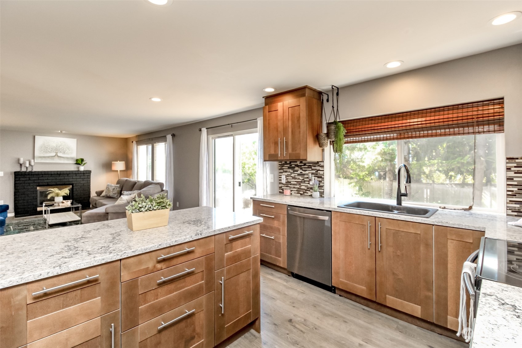 4609 Northeast 7th Place Renton, WA 98059 - Photo 4 of 30 a kitchen with granite countertop a stove and a sink