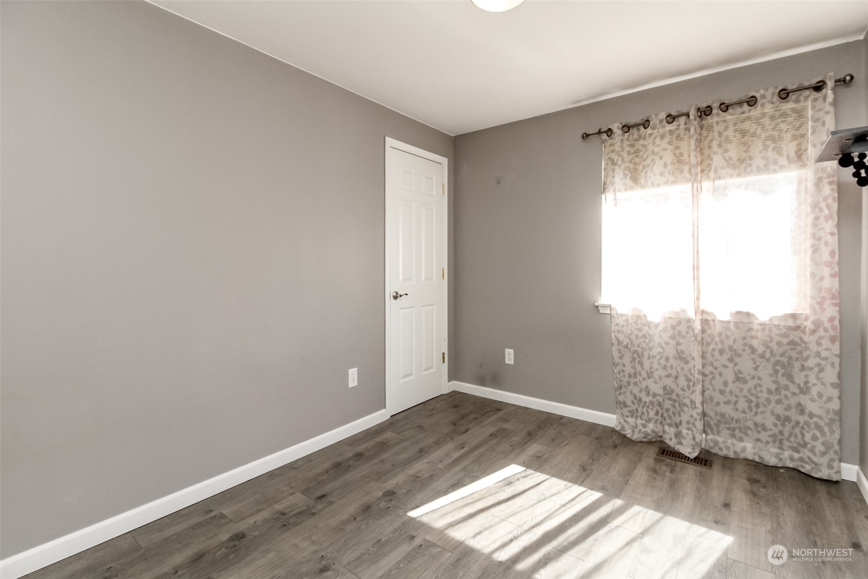 4609 Northeast 7th Place Renton, WA 98059 - Photo 9 of 30 a view of empty room with wooden floor and fan
