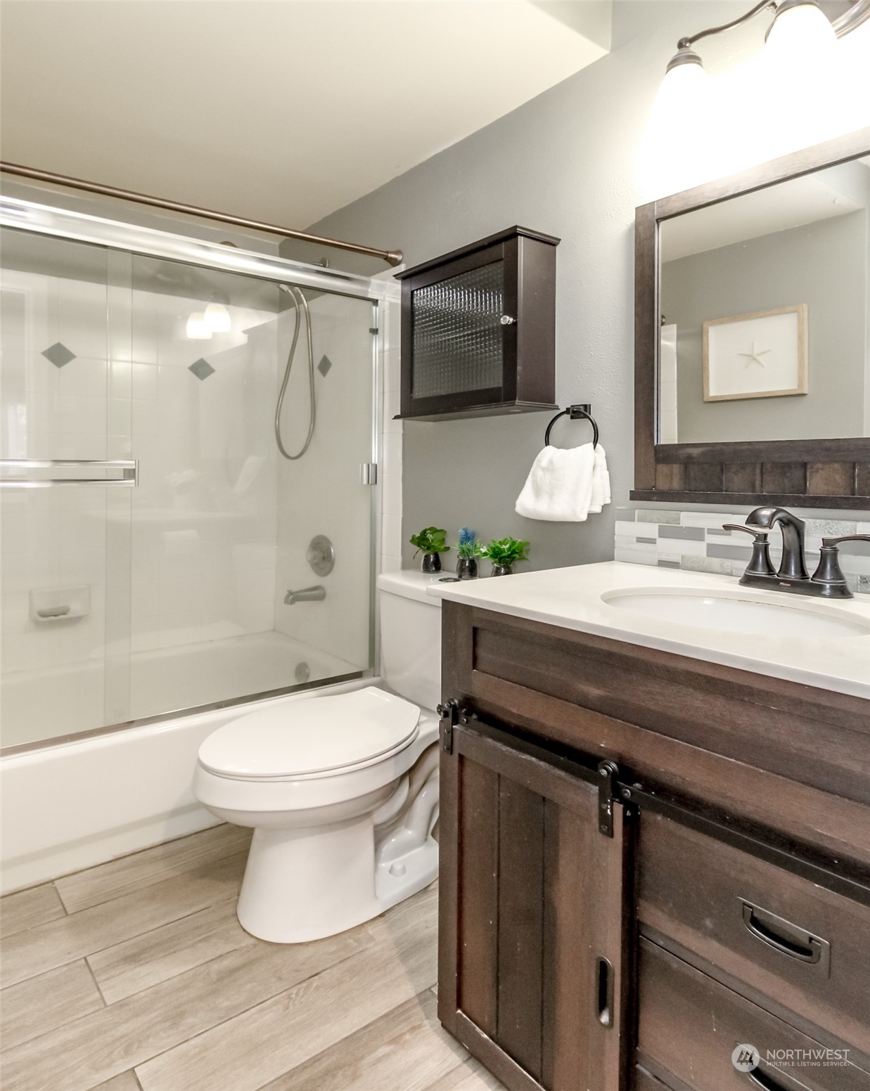 4609 Northeast 7th Place Renton, WA 98059 - Photo 10 of 30 a bathroom with a sink a toilet and shower