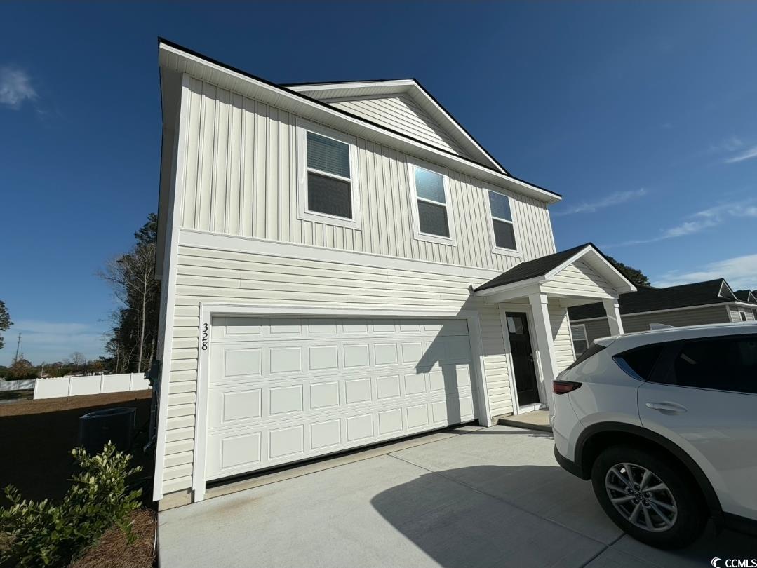328 Mistletoe Way Longs, SC 29568 - Photo 1 of 8 View of front facade with a garage, driveway, and board and batten siding