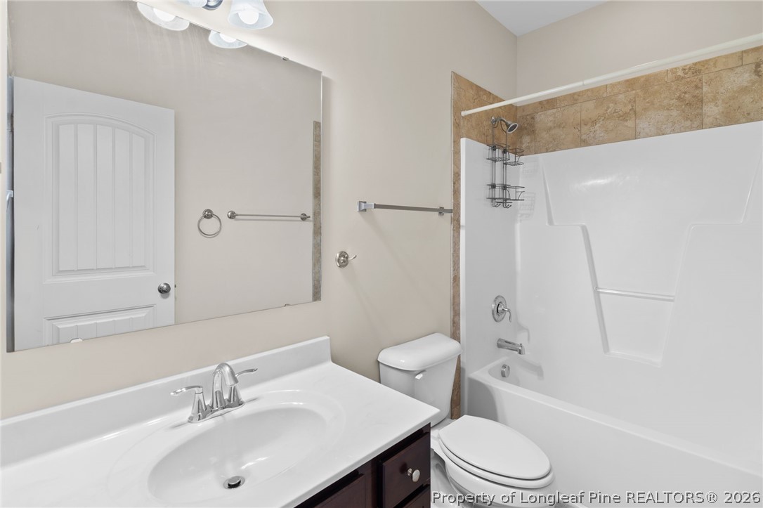 216 Meherrin Loop Raeford, NC 28376 - Photo 24 of 38 a bathroom with a sink toilet vanity and shower
