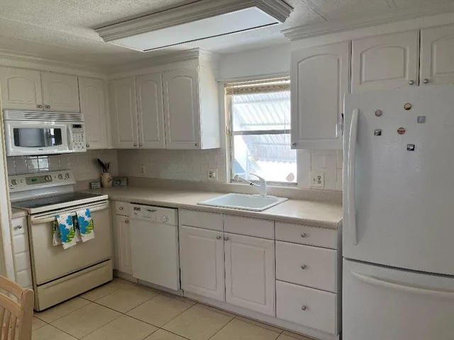a kitchen with cabinets appliances and a window