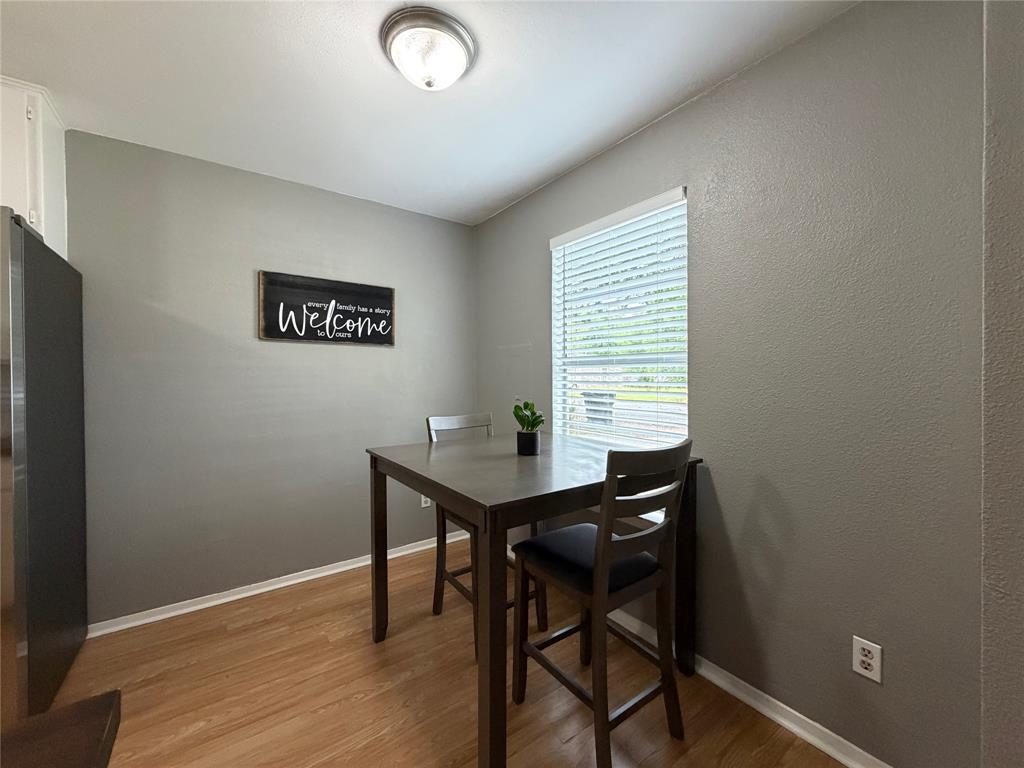 508 Batterson Street Cleburne, TX 76031 - Photo 19 of 28 Dining area featuring wood-finish flooring, gray painted walls, and a ceiling-mounted light fixture