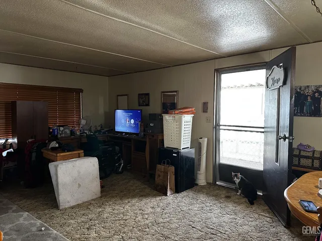 a living room with furniture a window and a flat screen tv