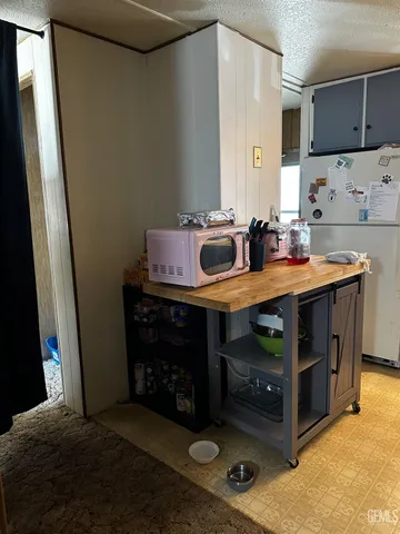 a view of kitchen with stainless steel appliances granite countertop a stove and a sink