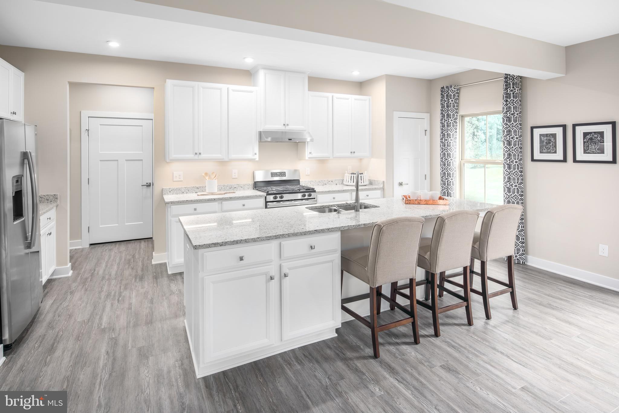 55 Wallace Way Ranson, WV 25438 - Photo 8 of 20 a kitchen with stainless steel appliances granite countertop a stove a sink dishwasher a microwave oven and a dining table with wooden floor