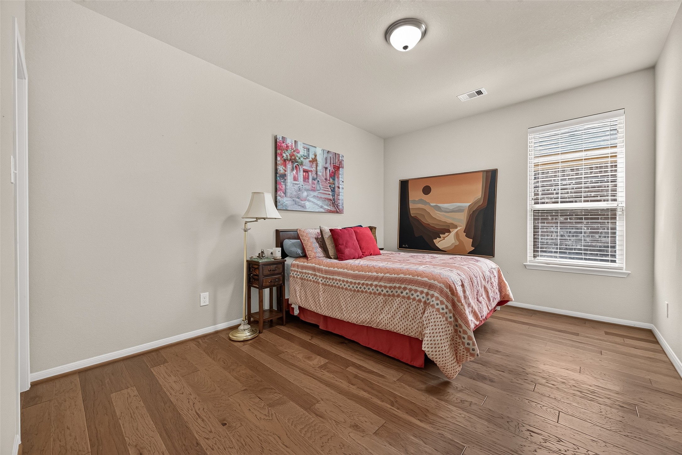 4910 Culver Lane Rosenberg, TX 77471 - Photo 18 of 50 Secondary bedroom with engineered wood floors, neutral walls, and natural light window. A relaxing retreat...
