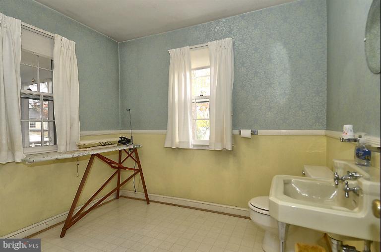 10163 Sutherland Road Silver Spring, MD 20901 - Photo 12 of 28 a bathroom with a sink window and a chair