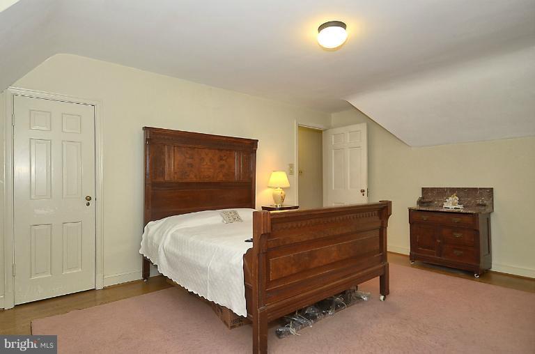 10163 Sutherland Road Silver Spring, MD 20901 - Photo 18 of 28 a bedroom with a bed and a night stand