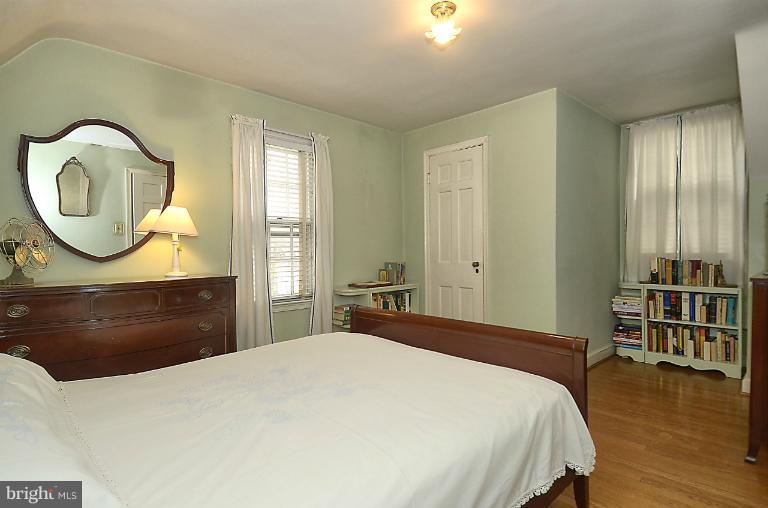 10163 Sutherland Road Silver Spring, MD 20901 - Photo 19 of 28 a bedroom with a bed and a dresser with mirror