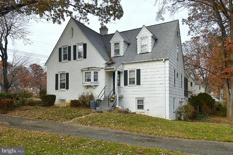 10163 Sutherland Road Silver Spring, MD 20901 - Photo 3 of 28 a view of a white house next to a yard with large trees