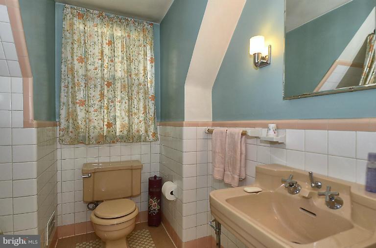 10163 Sutherland Road Silver Spring, MD 20901 - Photo 21 of 28 a bathroom with a sink a toilet and a mirror