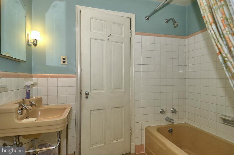 10163 Sutherland Road Silver Spring, MD 20901 - Photo 22 of 28 a bathroom with a tub a sink and a shower