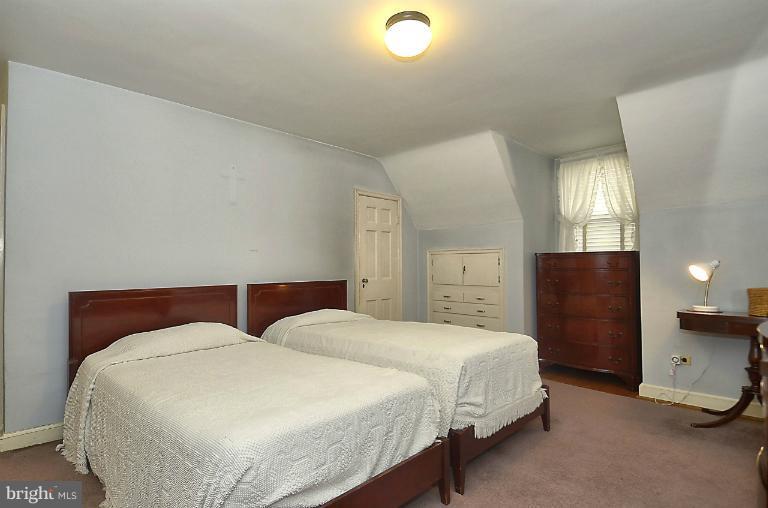 10163 Sutherland Road Silver Spring, MD 20901 - Photo 24 of 28 a bedroom with a bed and a chandelier
