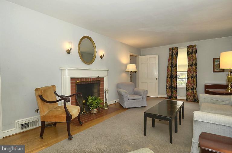 10163 Sutherland Road Silver Spring, MD 20901 - Photo 6 of 28 a living room with furniture and a fireplace