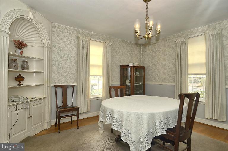 10163 Sutherland Road Silver Spring, MD 20901 - Photo 7 of 28 a dining room with furniture a chandelier and window