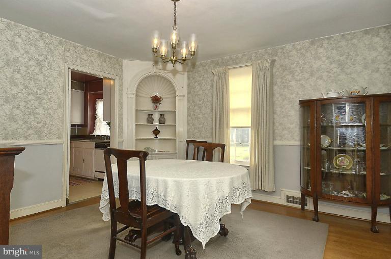10163 Sutherland Road Silver Spring, MD 20901 - Photo 8 of 28 a bedroom with a bed and a chandelier