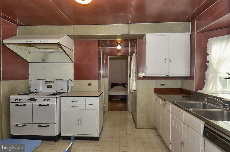 10163 Sutherland Road Silver Spring, MD 20901 - Photo 10 of 28 a kitchen that has a sink a stove and cabinets