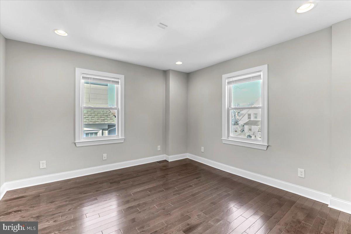 135 Sycamore Road Havertown, PA 19083 - Photo 16 of 33 a view of an empty room with wooden floor and a window