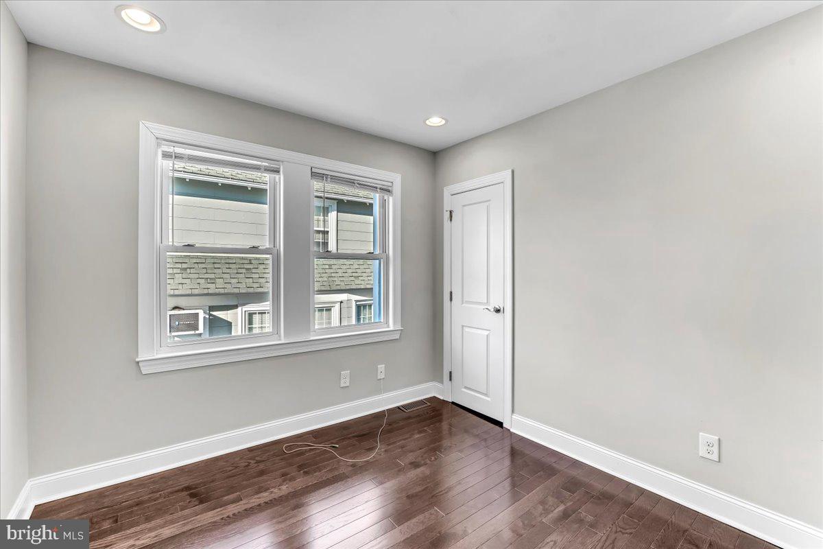 135 Sycamore Road Havertown, PA 19083 - Photo 17 of 33 an empty room with wooden floor and windows