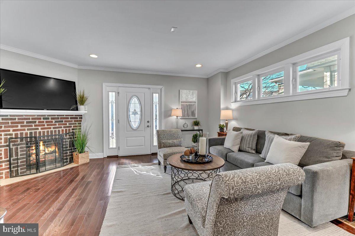135 Sycamore Road Havertown, PA 19083 - Photo 4 of 33 a living room with furniture a flat screen tv and a large window