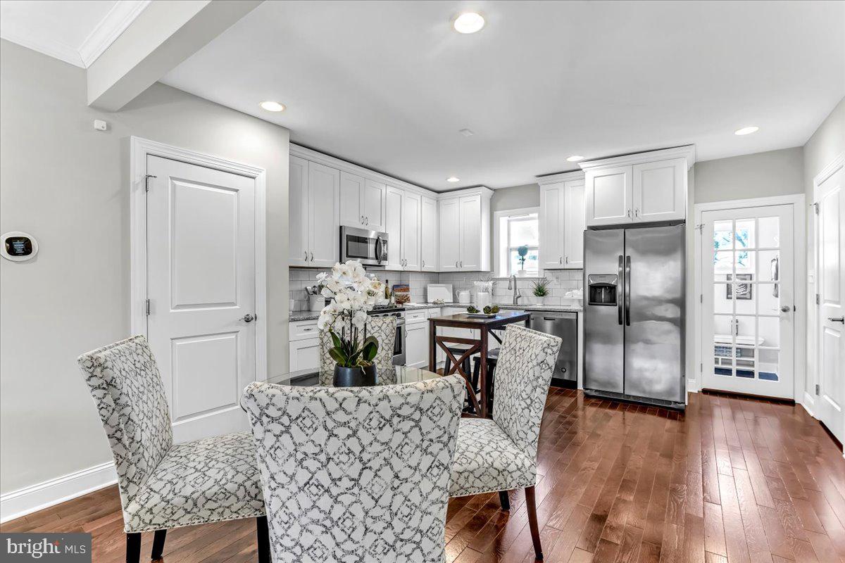 135 Sycamore Road Havertown, PA 19083 - Photo 7 of 33 a kitchen with refrigerator a sink and chairs