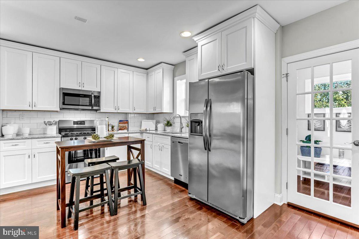 135 Sycamore Road Havertown, PA 19083 - Photo 8 of 33 a kitchen with kitchen island a large counter top space a sink stainless steel appliances and cabinets
