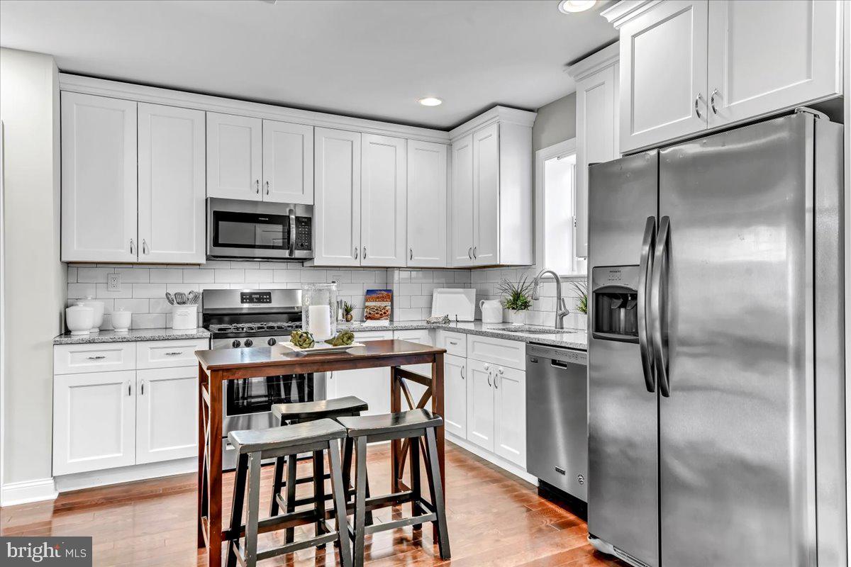 135 Sycamore Road Havertown, PA 19083 - Photo 9 of 33 a kitchen with a refrigerator and a stove top oven