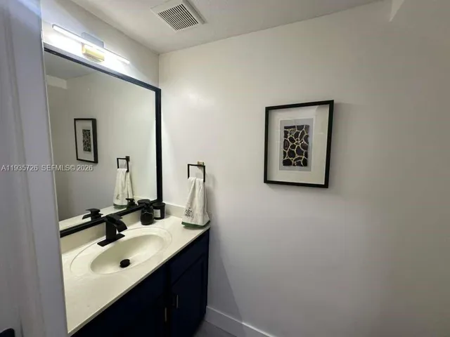 a view of a workspace with furniture and a flat screen tv