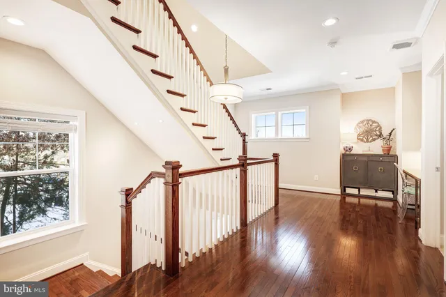 a view of entryway and hall with wooden floor