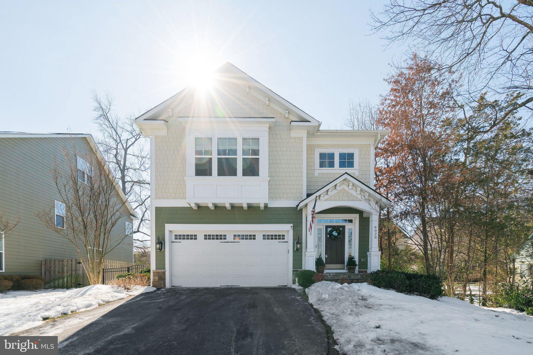 8028 Wellington Road Alexandria, VA 22308 - Photo 2 of 48 a front view of a house with a yard and garage