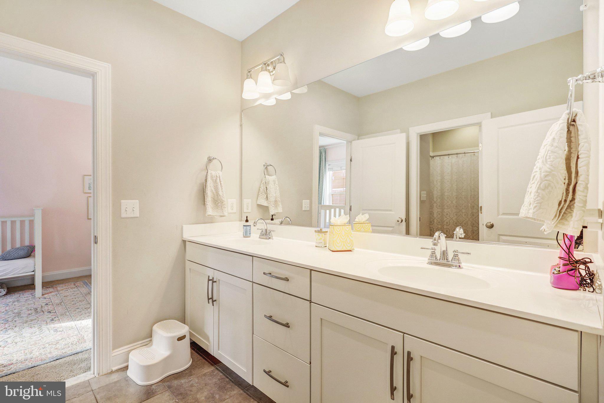 8028 Wellington Road Alexandria, VA 22308 - Photo 22 of 48 a bathroom with a double vanity sink mirror and toilet