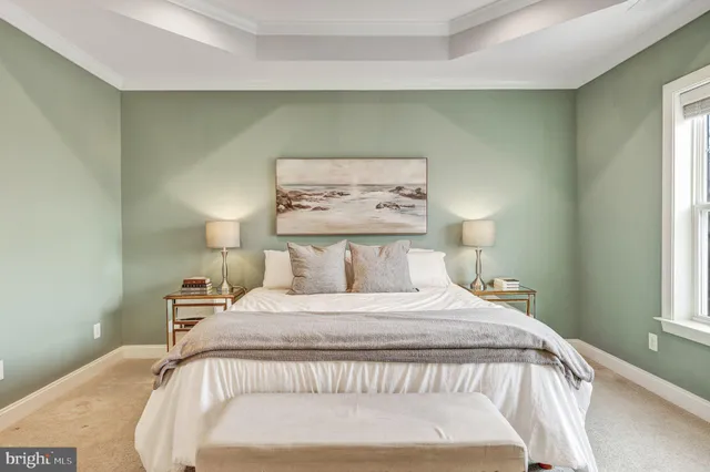 a bedroom with a bed and a painting on the wall