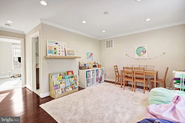 a bedroom with furniture and a wooden floor