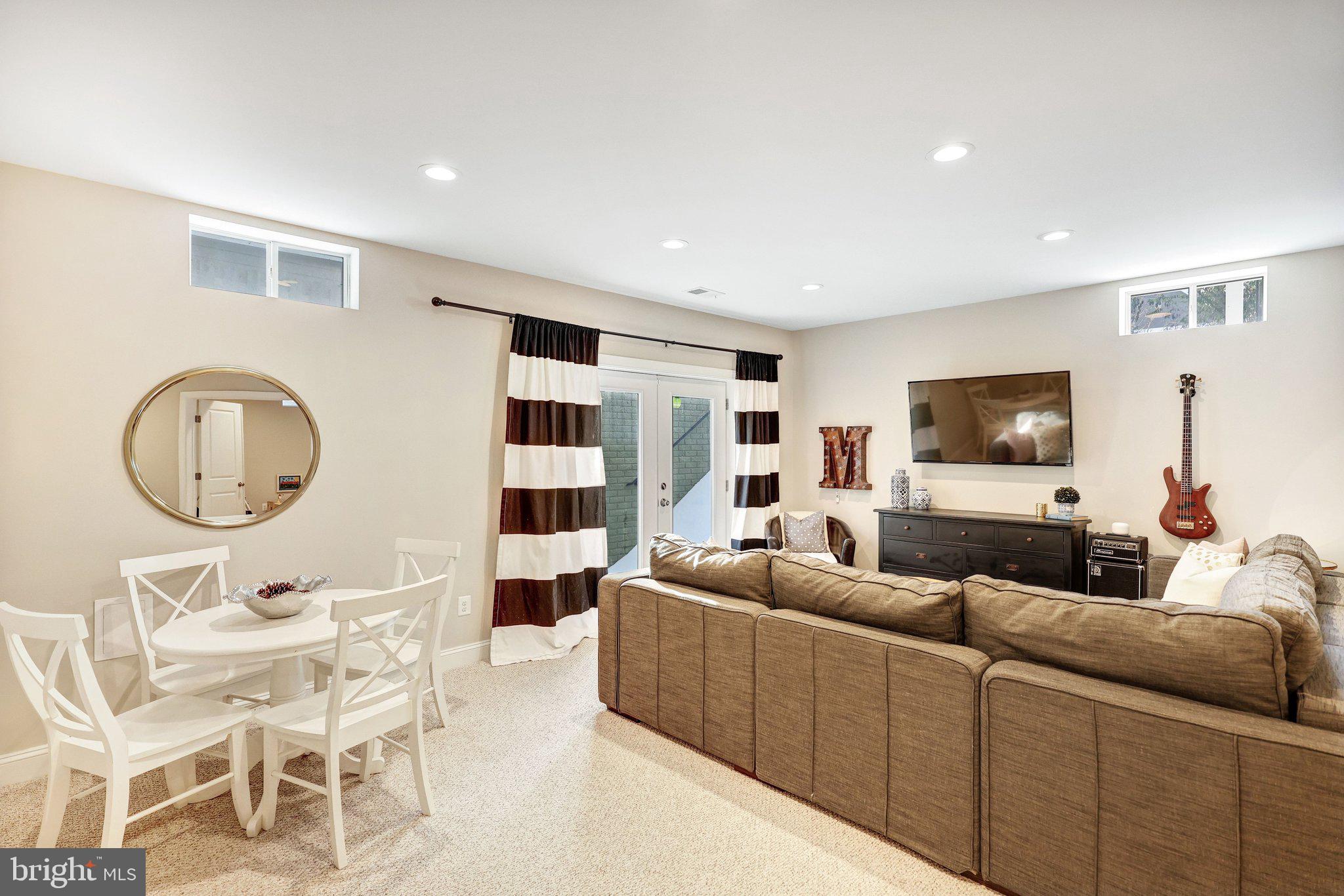 8028 Wellington Road Alexandria, VA 22308 - Photo 34 of 43 a living room with furniture and a flat screen tv