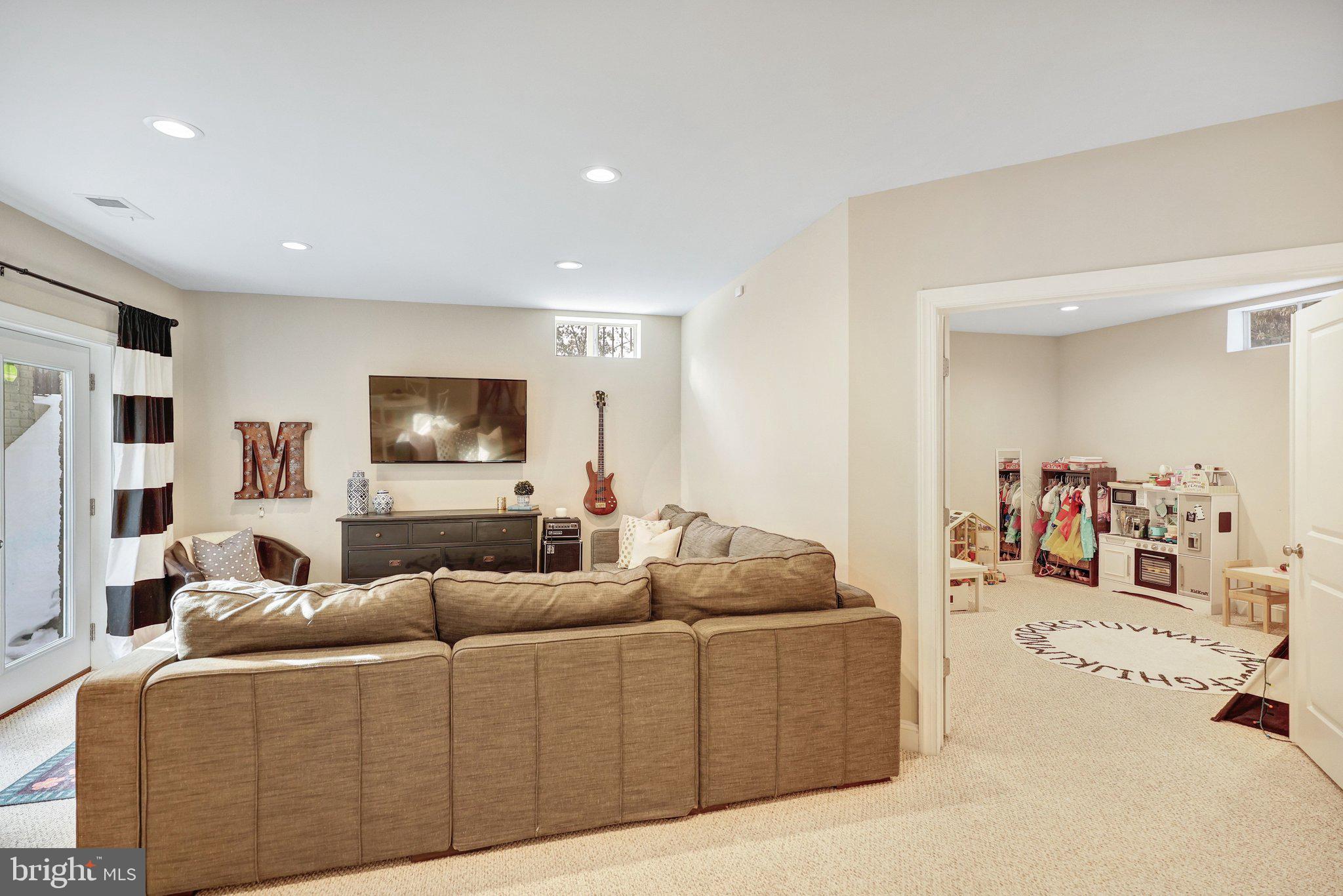 8028 Wellington Road Alexandria, VA 22308 - Photo 35 of 43 a living room with furniture and a flat screen tv
