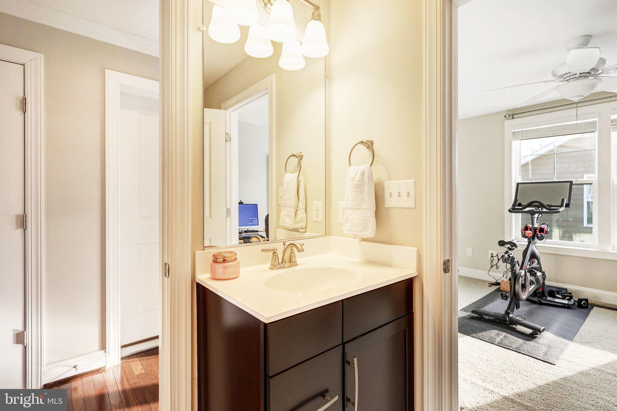 8028 Wellington Road Alexandria, VA 22308 - Photo 36 of 48 a bathroom with a sink vanity and mirror
