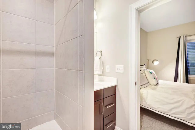 a bedroom with a bed and a shower