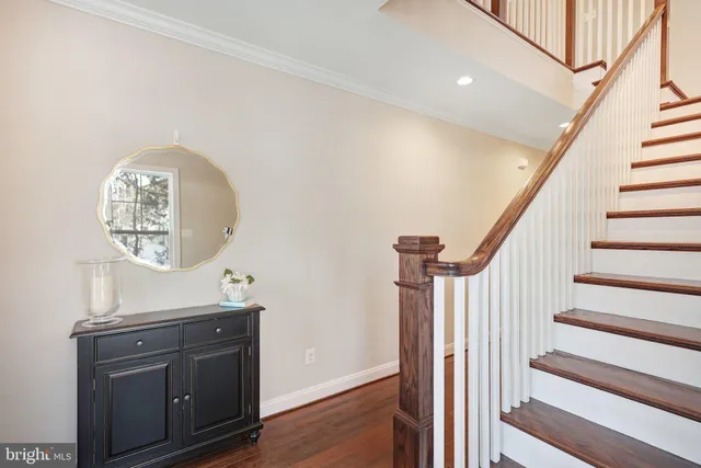 a view of a hallway with wooden floor and entryway