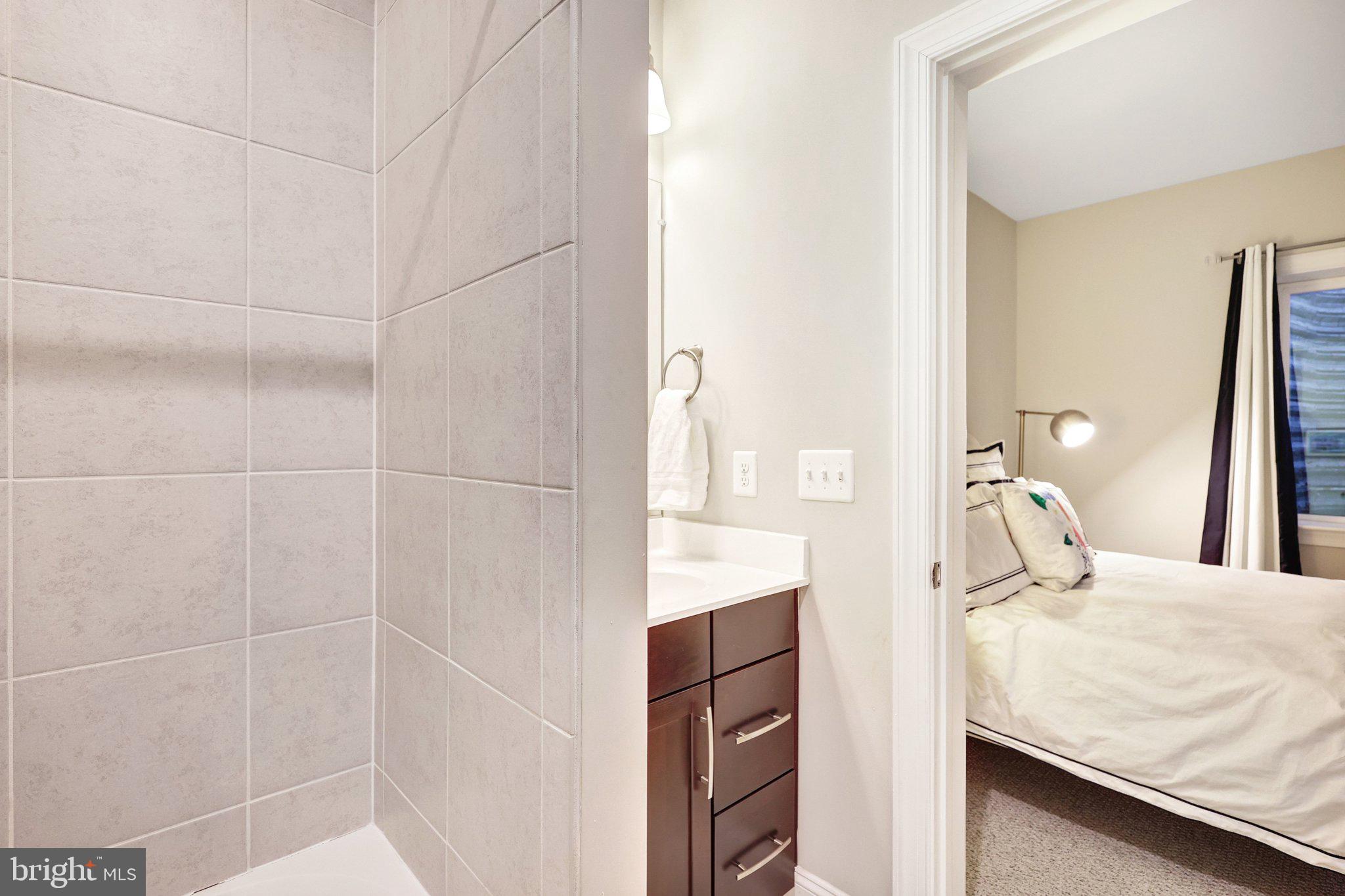 8028 Wellington Road Alexandria, VA 22308 - Photo 42 of 48 a bedroom with a bed and a shower