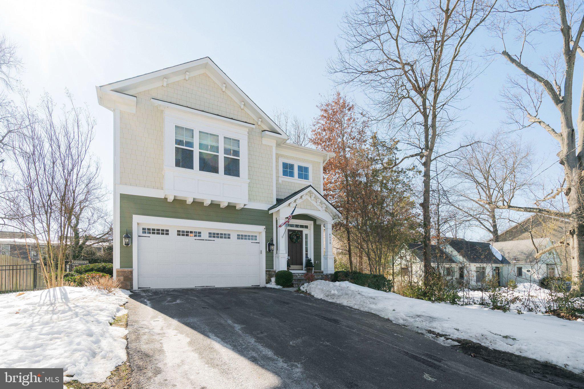 8028 Wellington Road Alexandria, VA 22308 - Photo 5 of 48 a front view of a house with a yard covered in snow