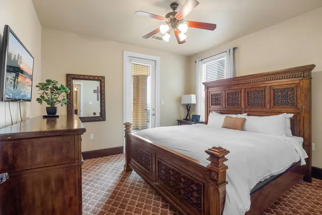 a bedroom with a bed and a chandelier