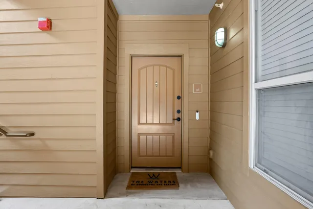 a front view of a house with swimming pool and porch